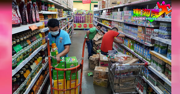 商品供应商员工开始在超市忙碌安排货品上架工作。
