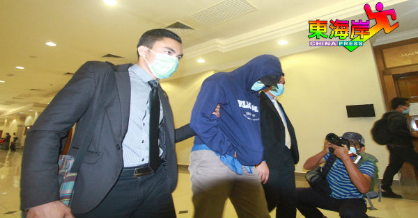 被告诺希山哈米丁（左2）被判决监刑后，由两名反贪会官员带离关丹地庭。