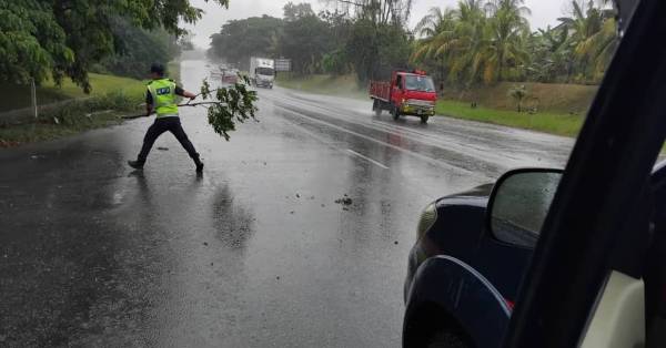 巡逻期间发现路有障碍异物，官员不惜冒雨下车移除。